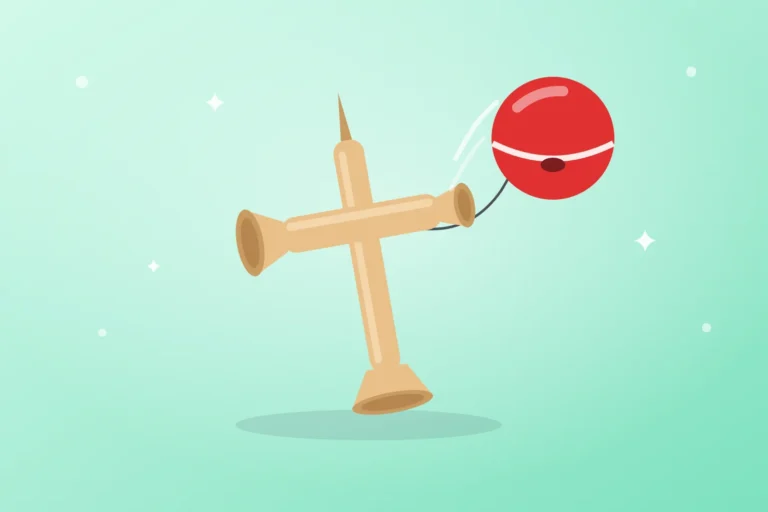 Drewniana kendama z czerwoną kulką na sznurku